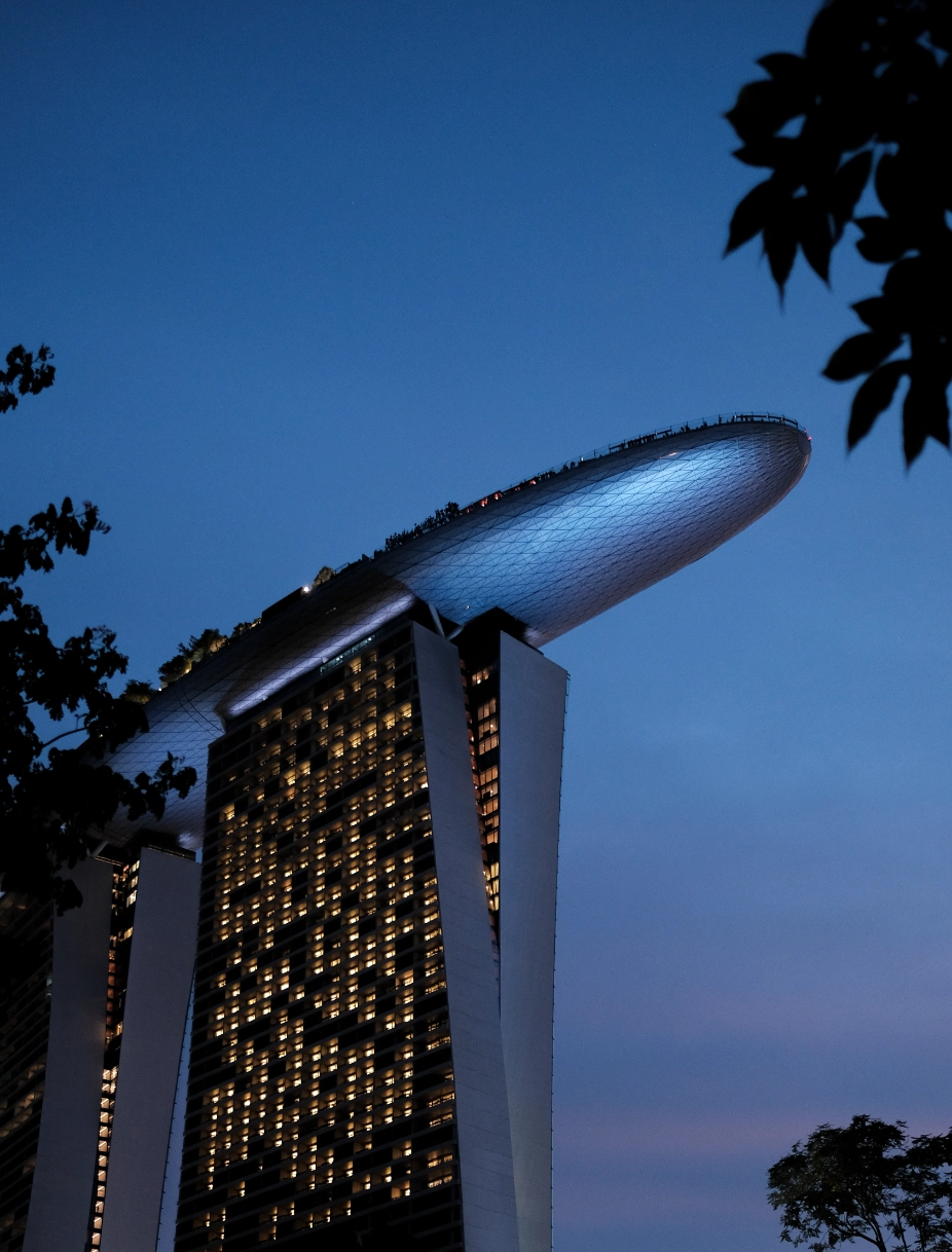 Marina Bay Sands iconic architecture at twilight with illuminated windows empowering Singapore's largest employer operations