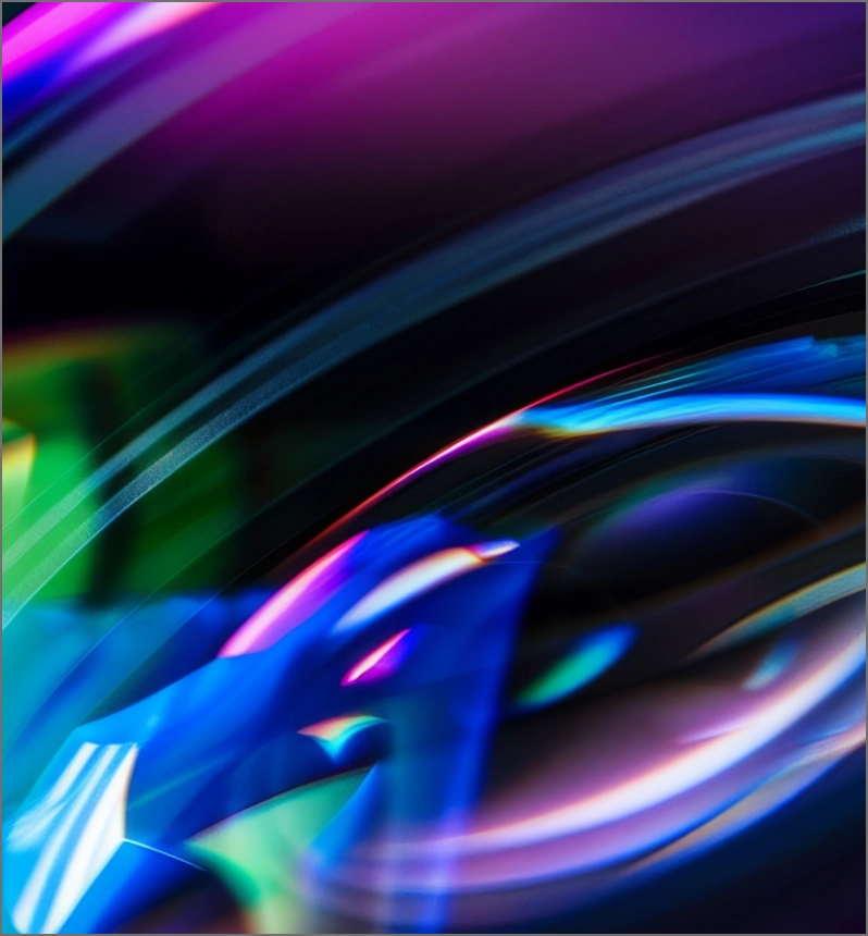 Abstract neon waves in pink, blue, and green flowing across a dark background with smooth motion blur effects