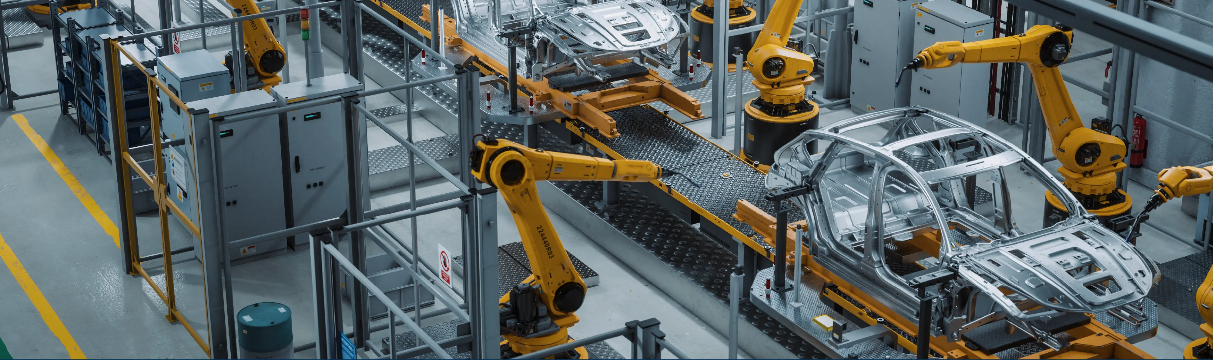 Robotic arms assembling car body frames on an automated production line inside a modern automotive facility