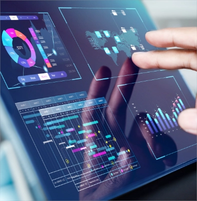 Hand holding transparent card with financial charts over tablet displaying colorful interactive dashboard analytics