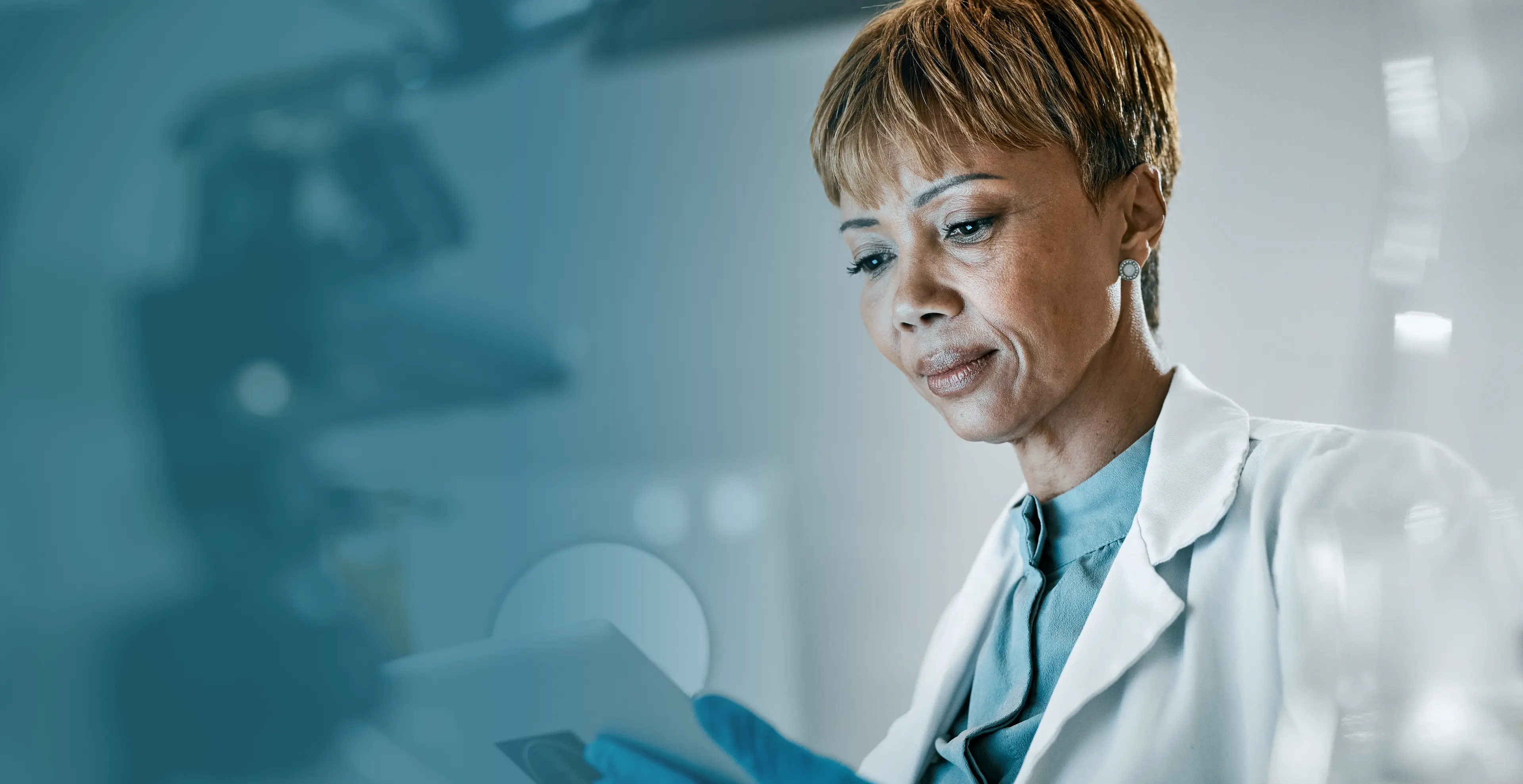 Professional female doctor in white coat reviewing patient records in modern healthcare facility with clinical background